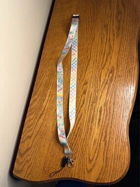 Disney Dumbo Pin reading lanyard id holder